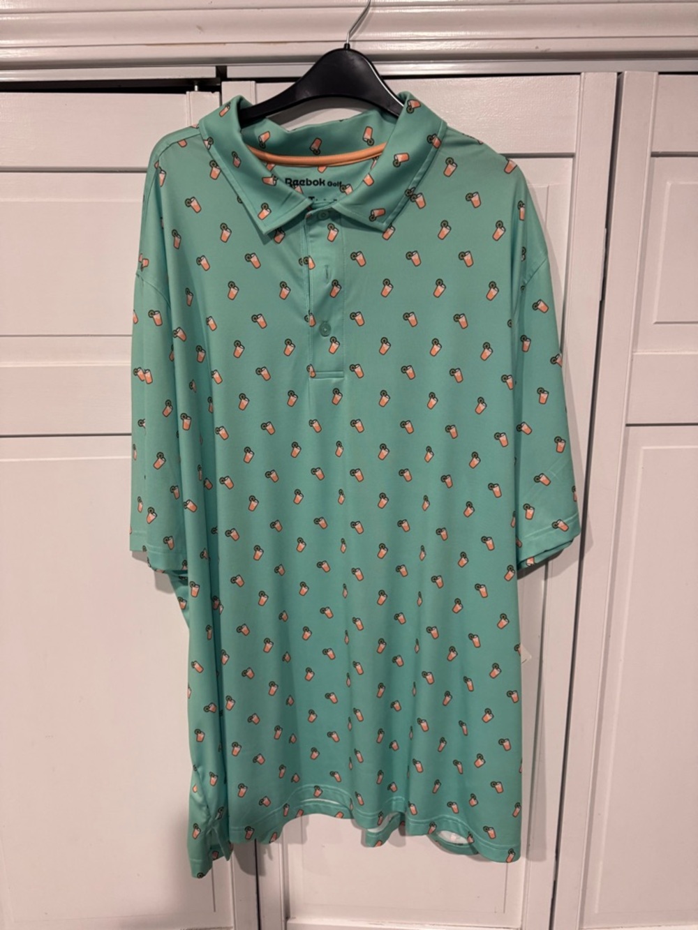 Reebok Men’s Mint Green Polo with Peach Novelty Print